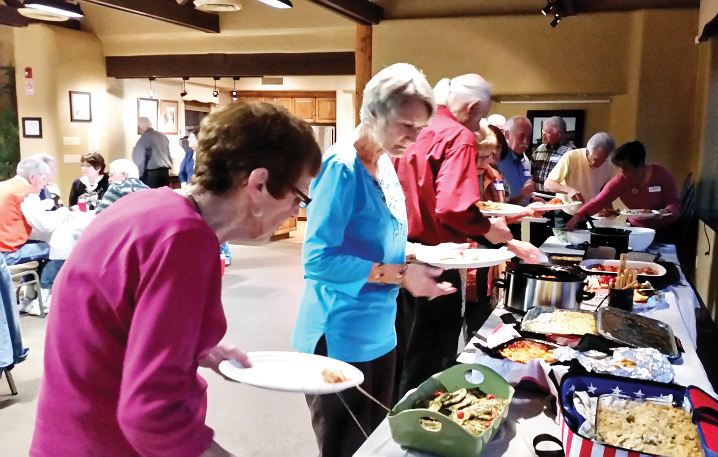 Residents make their selections from an array of delicious Italian foods.