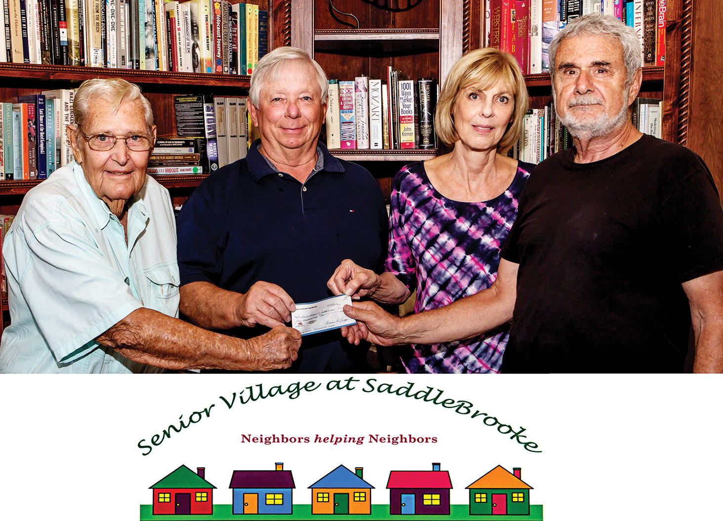 Lloyd Maritz of The Variety Show and Bill Trapp of The SaddleBrooke Theatre Guild hand a donation check to Steve and Susan Shear, founding members of Senior Village at SaddleBrooke.