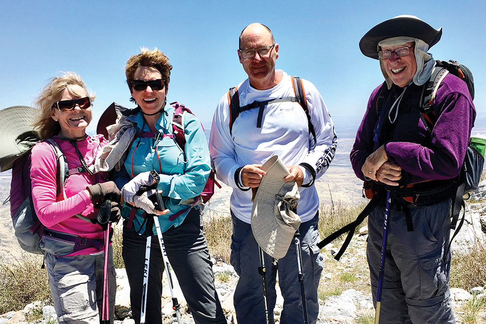 Standing at the windy summit of Miller Peak in the Huachuca Mountains are (left to right) Bertie Litchfield, Donna Canon, Pete Canon and Aaron Schoenberg; not pictured are Frank Earnest and Don Taylor.