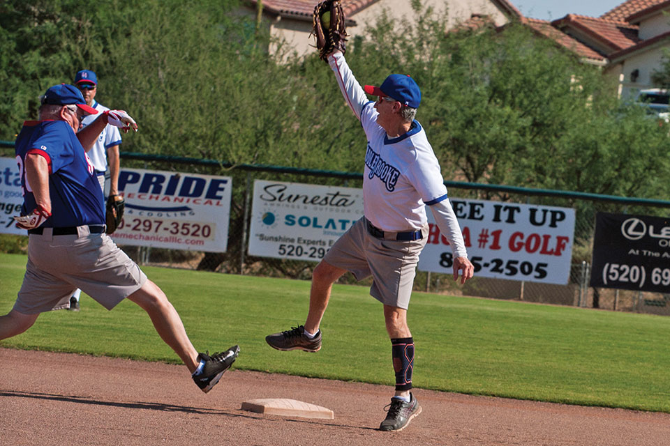 Recreation: Second baseman Dennis Purcell leaps to catch the throw as Dale Norgard stretches to reach second base safely; photo by Cathy Purcell