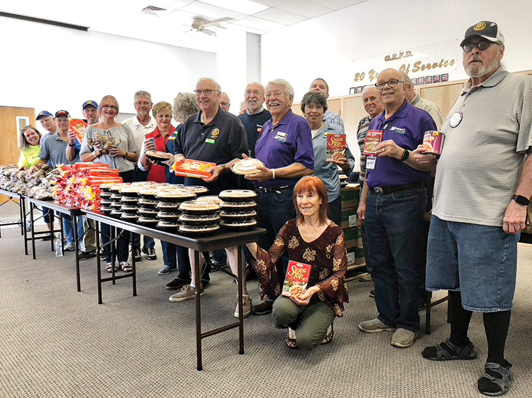 Members of the Rotary Club of SaddleBrooke team up with the board of directors of IMPACT of Southern Arizona, the Golder Ranch Fire Department, and the Elks Lodge to help provide Thanksgiving dinners for area residents in need.