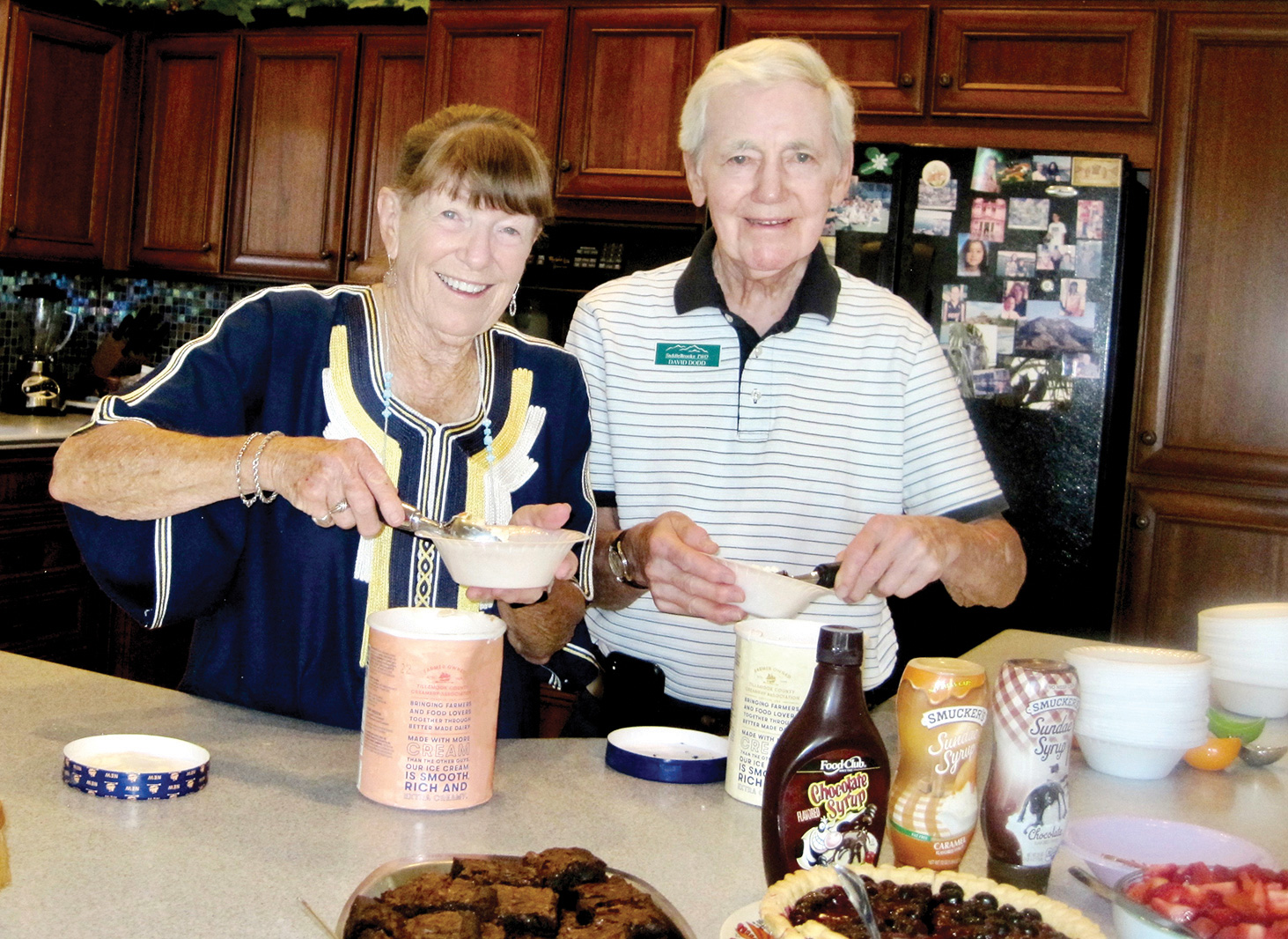 Arlene DesJardins and David Dodd serving up dishes of ice cream