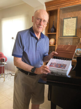 Chuck Aurand with the inventory catalogue of his recent musical instrument donation to Michigan State University (Photo by Sue Case)