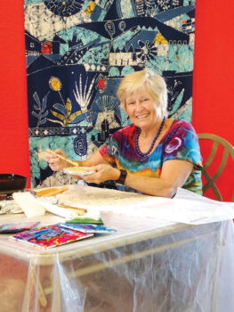 Greta von Wrangel carefully applies wax in a detailed pattern as she creates a batik design. (Photo by LaVerne Kyriss)