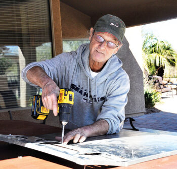 Senior Village volunteer Steve Wiley repairs a panel for a member’s spa.