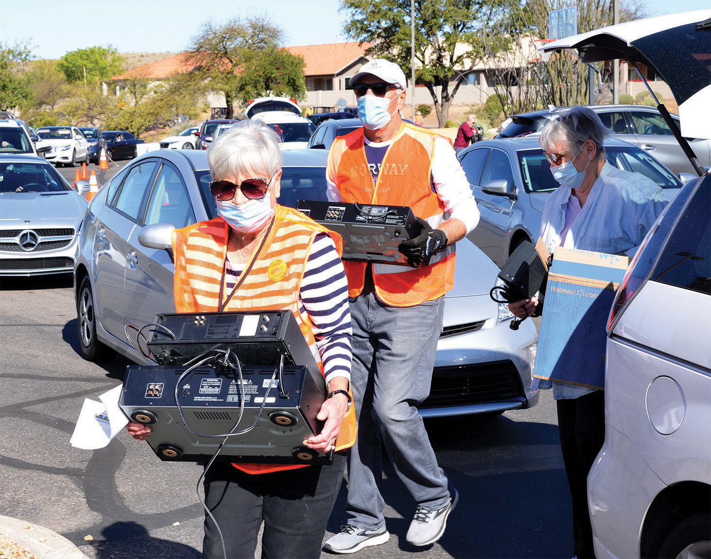 Senior Village volunteers unload electronics for recycling.
