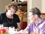 Sigrid Silverman, social chairperson, left, and Gretchen Kolsrud confer on plans for the May picnic at the April luncheon.