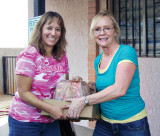 From left: Exalted Ruler Gloria Cisneros and Community Activities Coordinator Jan Trudeau loading truck with bags of food.