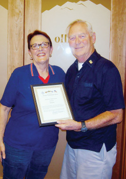 Kim Sloan, LAVFW, receives a certificate of appreciation from George Bidwell (right), President of SaddleBrooke Troop Support.