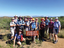 On the Arizona National Scenic Trail in Oracle are, left to right, Janis and Norm Rechkemmer, Elaine (kneeling) and Howie Fagan, Ray Peale, Anne Hammond, Chris Swenson, Sandra Sowell, Mary Croft, Arlene Gerety, Jerry Morris, Rosemarie McGoldrick and Lissa White; photo by Elisabeth Wheeler.