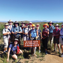 On the Arizona National Scenic Trail in Oracle are, left to right, Janis and Norm Rechkemmer, Elaine (kneeling) and Howie Fagan, Ray Peale, Anne Hammond, Chris Swenson, Sandra Sowell, Mary Croft, Arlene Gerety, Jerry Morris, Rosemarie McGoldrick and Lissa White; photo by Elisabeth Wheeler.