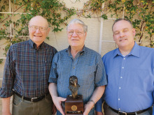 Flanked by Golden Eagles chair John Wiley (left) and Catalina Council Executive Ken Tucker, Roger Bogard holds his bronze eagle awarded to him by his colleagues.