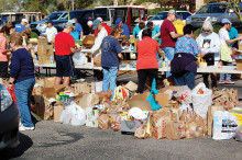 Volunteers sort food for the annual community food drive benefiting the Tri Communities.