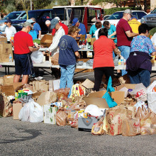 Volunteers sort food for the annual community food drive benefiting the Tri Communities.