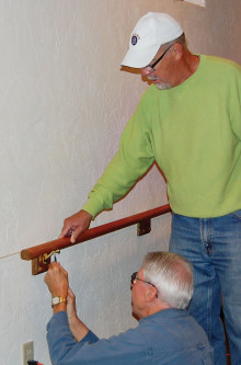 Dave Smith (left) and Dan Linegar attach a rail.