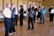 Instructors Jeanny and Wally Mara teaching a Merengue figure