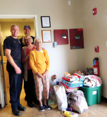 Willie Reich and Helen Nack deliver toys to SaddleBrooke firemen.