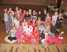 The SaddleBrooke Line Dancers share secrets in their pj’s.