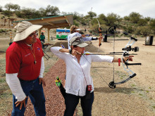 Level Four National System Coach Lawrence Brady looks on as Pam Vassalio focuses on her target.