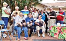 The Shih Tzus brought their owners to hear Dr. Dimitri Brown.