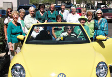 SaddleBrooke Line Dancers try to squeeze into a Volkswagen Beetle.