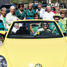 SaddleBrooke Line Dancers try to squeeze into a Volkswagen Beetle.