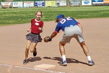 This young lady avoids the tag from Coach Q and she is safe at third base! Photo by Jim Smith.