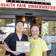 Ken Siarkiewicz, Health Fair Chair, presents a certificate thanking Sheftel Healthy Skin for underwriting the Health Fair.