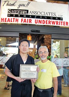 Ken Siarkiewicz, Health Fair Chair, presents a certificate thanking Sheftel Healthy Skin for underwriting the Health Fair.