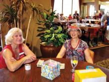 Ann Cristofani and Marcia Munich greet MVLPutters at the July luncheon.