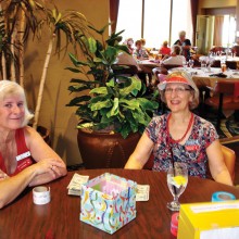 Ann Cristofani and Marcia Munich greet MVLPutters at the July luncheon.