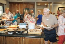 A potluck dinner is enjoyed by many.