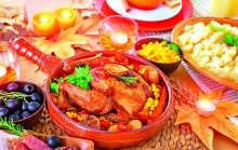 Oven roasted Thanksgiving Turkey on centerpiece of beautiful decorated festive table, healthy and tasty family dinner, traditional autumn holiday