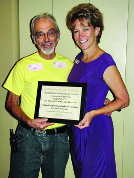 Health Fair Chairman Ken Siarkiewicz presents Barbara McClure, IMPACT of Southern Arizona, with a certificate of appreciation.