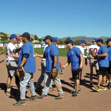 SSSA all-stars (white shirts) congratulate the victorious Northwest firefighters (in blue) after the game three thumping of the geezer team. Photo by Pat Tiefenbach.