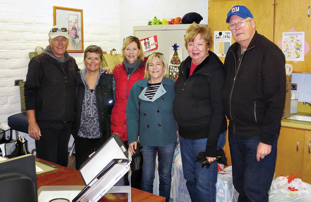 Left to right: Committee members after delivering the gifts and food bags to the school include Peter Bratz, Carol Smith, Marlene Diskin, Judi Cosel-Slavin and Camille and Ken Hovmiller.