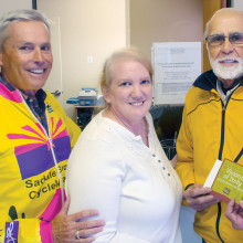 Jack Giovinco, Coordinator of the CycleMasters Progress Delivery Team, presents Sue Kreund-Krause with a thank you gift from SaddleBrooke Cyclemasters. CycleMasters Jeff Eighmy looks on.