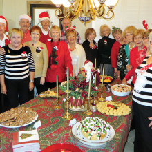 With several of their men helpers behind them, the Old Wise Ladies of Resurrection Church are ready for Cheer, Cheese and Chatter.