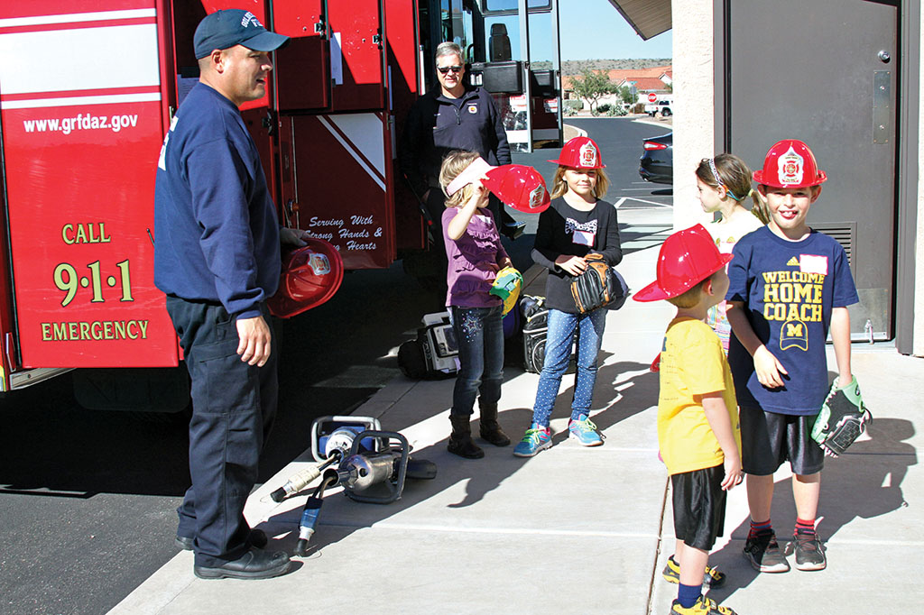 It’s a hit when Golder Ranch Firefighters show the kids how a real fire truck works; photo by Jim Smith.