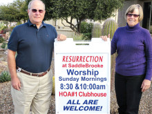 Steve and Marty Harsch with a Resurrection Church sign