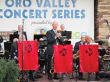 Director Ed Sand welcomes the audience and introduces music sung by Frank Sinatra; photo by Georgie Hourigan.