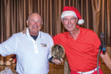 Left to right: Mike Harris receiving trophy from interim Tournament Director Mick Borm