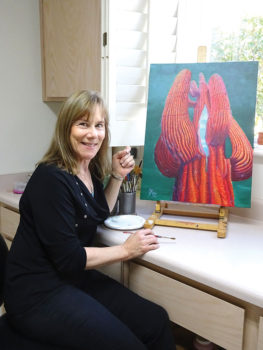 Jannette Borland pauses in her studio space with Blue Sky Within.