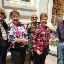 In front of the 1910 synagogue are Quester members Marilyn Bertke, Rose Meyer, Linda Holt and Libby Cohen presenting the check to JHM Board President Barry Friedman.