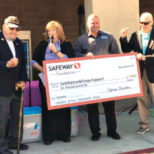 Safeway Store Manager Wendy Anderson and District Manager Jimmy Seaver present check to SaddleBrooke Troop Support President George Bidwell and Moose Creighton, announcing STS would receive an additional $5,000 grant award.