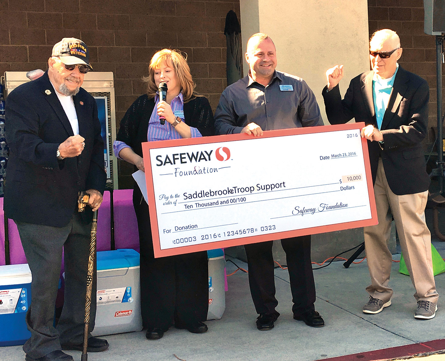 Safeway Store Manager Wendy Anderson and District Manager Jimmy Seaver present check to SaddleBrooke Troop Support President George Bidwell and Moose Creighton, announcing STS would receive an additional $5,000 grant award.