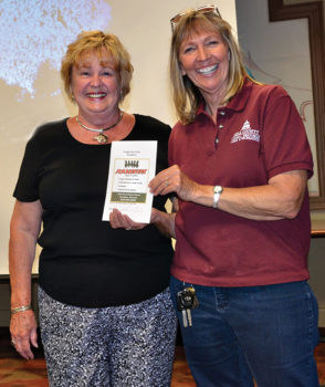 Speaker Sandy Reith (left) giving door prize for the month to Lois LaNassa; photo by Ed Skaff