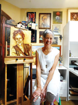 Karen Warner pauses in her studio with an in-progress portrait.