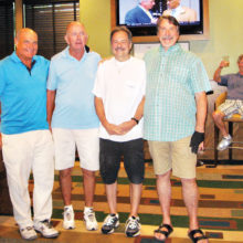 Left to right: Bruce Fink second place, Larry Tipton fourth place, Paul “Bankster” Callas first place, Tom “Half Jacket” Barrett third place. Lurking in the background is Dominic “The Doctor” Borland sitting in his very familiar chair.