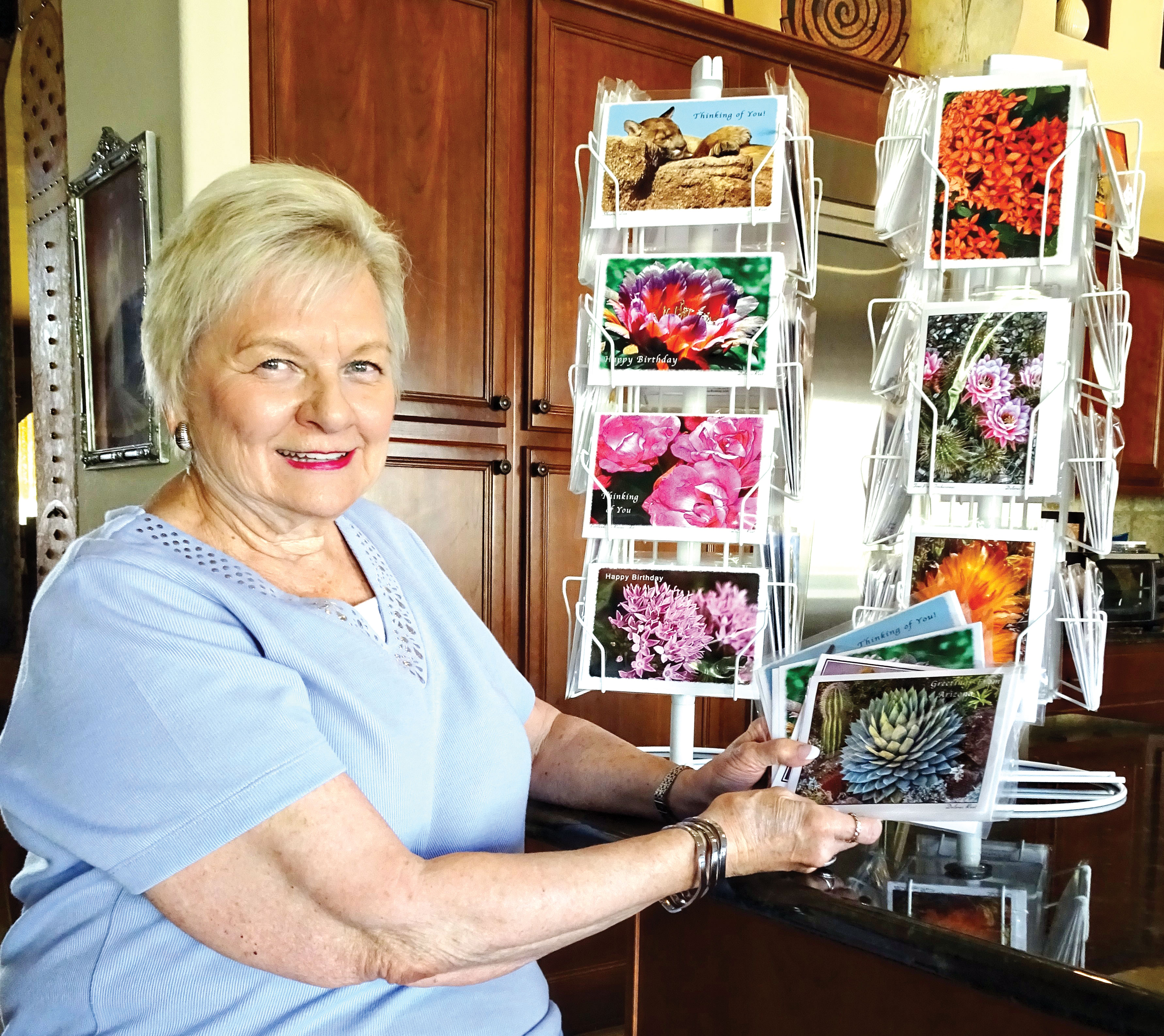 Dolores Root examines a few of the notecards she’s created featuring some of her award-winning photographs.